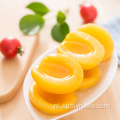Fabriek verkoopt gele perzik fruit ingeblikt
